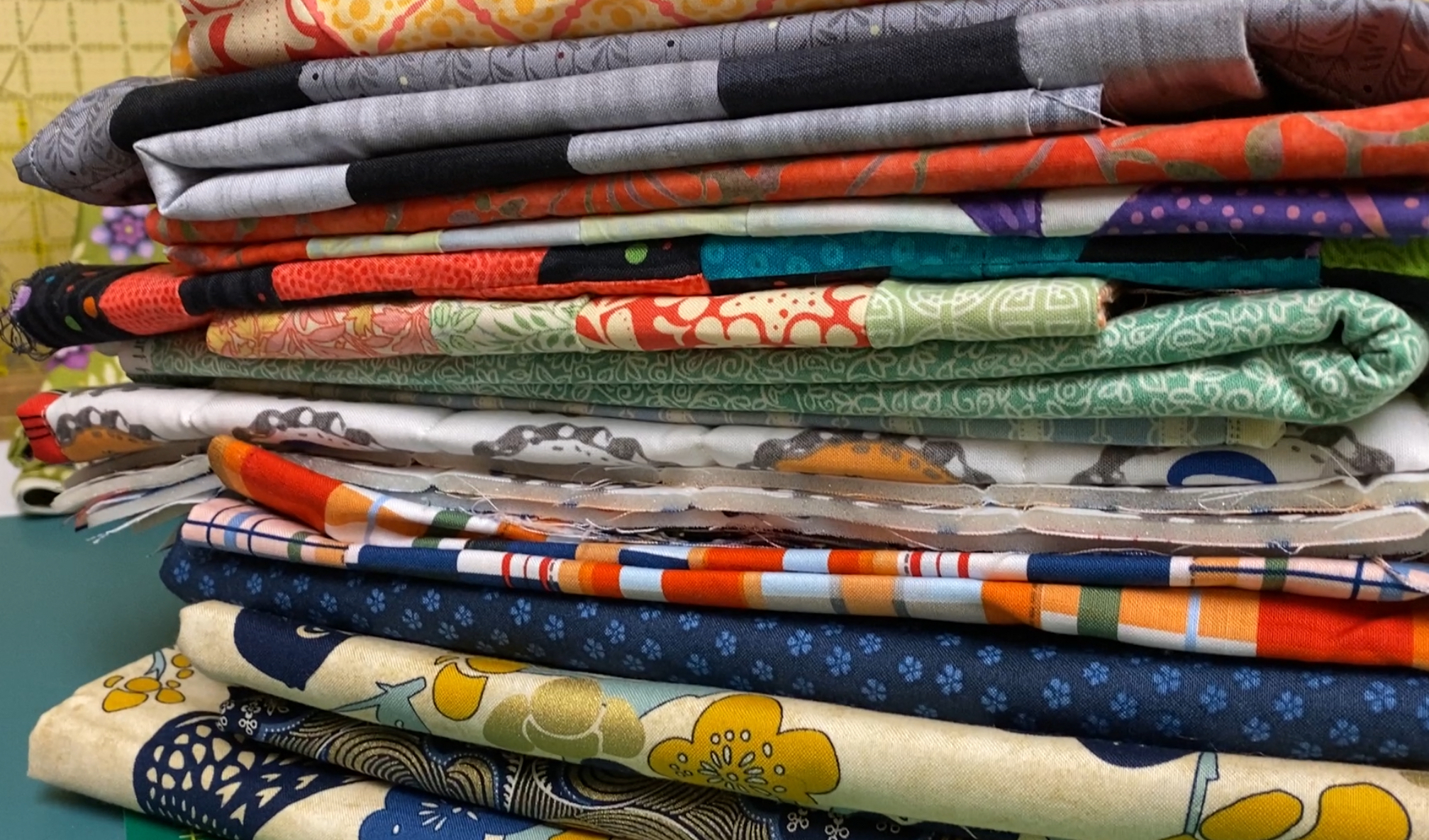 Stack of unfinished quilting projects