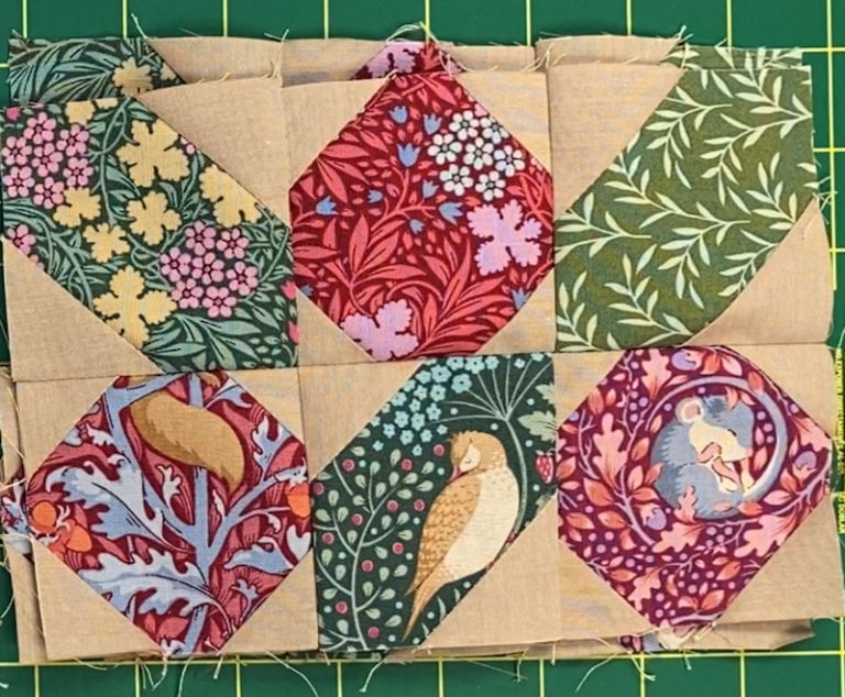 edge segment of quilt block consisting of three red berries and three leaves