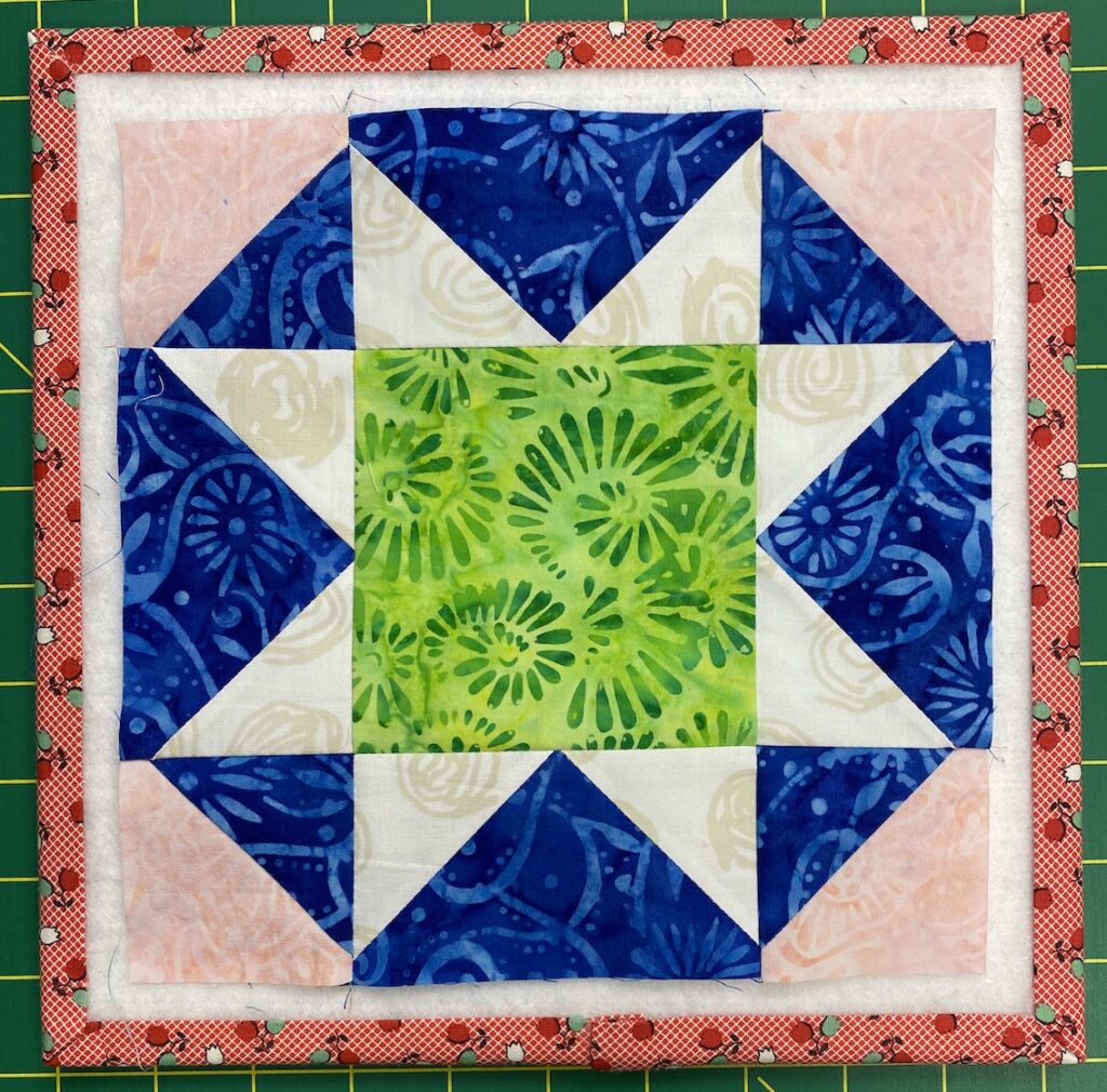 Finished Mosaic Star quilt block on a small design board