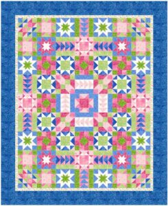 Colorful quilt in pinks, blues, and greens with many blocks featuring stars.
