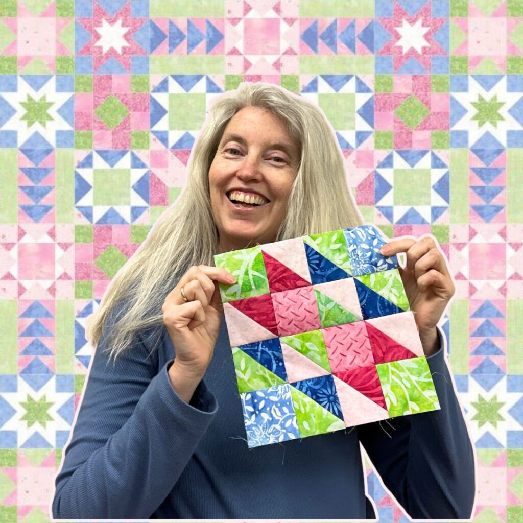 Stacy holding a Hovering Hawks quilt block