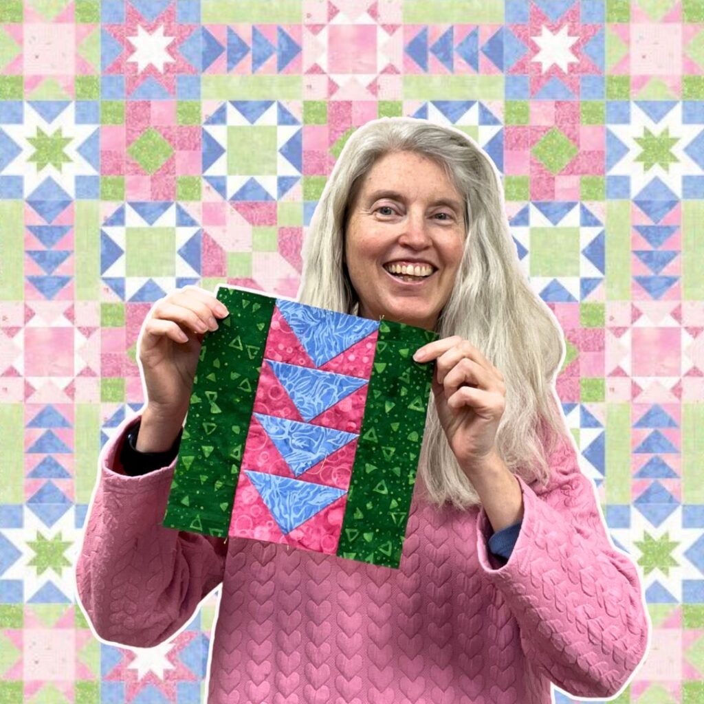 Stacy holding a flying geese block