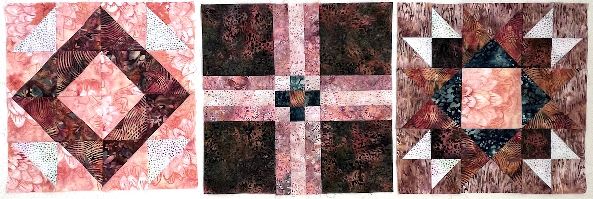 Three quilt blocks in pinks and terracotta.