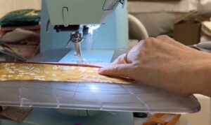 feeding fabric strips through sewing machine